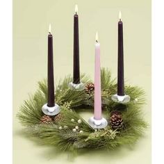 a wreath with three candles and pine cones