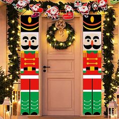 christmas decorations on the front door of a house with wreaths and lights around it