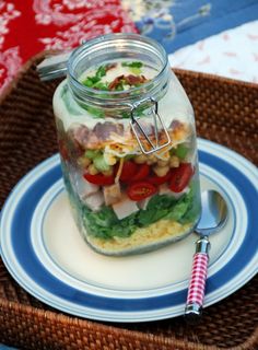 a glass jar filled with food sitting on top of a blue and white plate