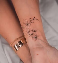 two women with matching tattoos on their wrist