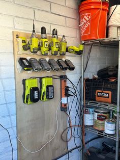 there are many different tools on the wall in this garage, including drillers and screwdrivers