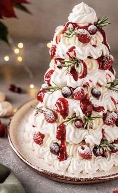 a christmas tree made out of meringue and strawberries on a platter