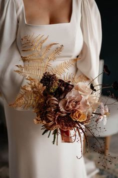 Bride holding an autumnal wedding bouquet with neutral flowers, orange tones and dried grass Grass Wedding Bouquet, Humanist Wedding Ceremony, Brown Wedding Themes, Fern Bouquet, Flower Cloud, Neutral Flowers, Autumnal Wedding, Flowers Autumn, Dried Flowers Wedding