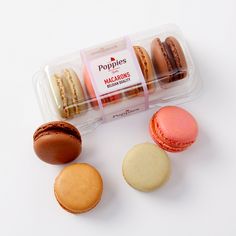 an assortment of macaroons in a plastic container