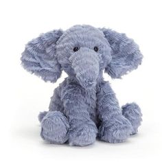 a small stuffed elephant sitting on top of a white floor