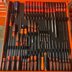 an orange tool box filled with different tools