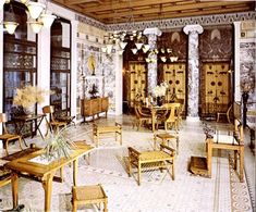 an old fashioned living room filled with lots of furniture and decor on top of tile flooring