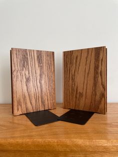 two pieces of wood sitting on top of a wooden table