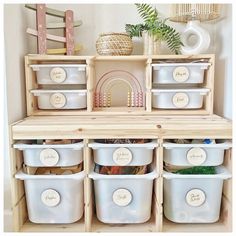 several white plastic containers with labels on them are stacked in front of a wooden shelf