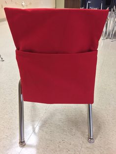 a red chair sitting on top of a tile floor