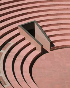 an aerial view of a circular building with steps