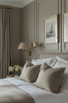 a bed with white linens and pillows in a bedroom next to a large window