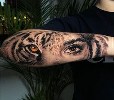 a man with a tiger eye tattoo on his arm