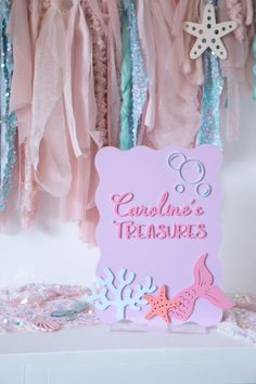 there is a pink sign that says carolina's treasures on it and some decorations