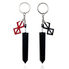 two black and red metal key chains with crosses on each one, both hanging from the same