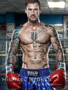 a man with tattoos and boxing gloves on