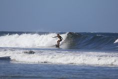 a person riding a wave on top of a surfboard