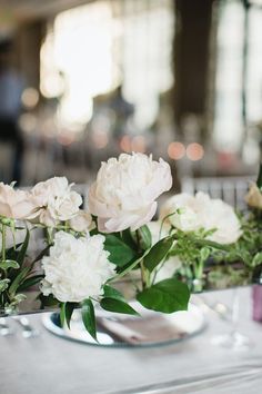 some white flowers are sitting on a table