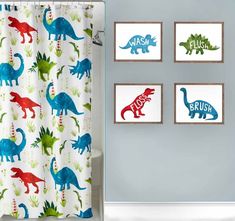 bathroom with dinosaur shower curtain, bath rug and toilet paper roll holders on the wall