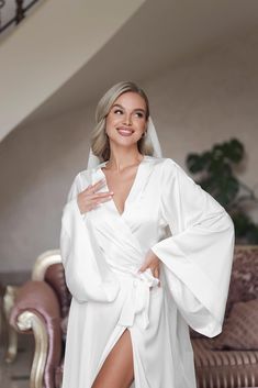 a woman in a white robe posing for the camera