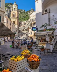 oranges and lemons are in baskets on the street