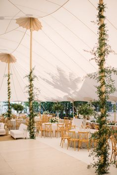 an outdoor dining area with tables, chairs and umbrellas set up for a party