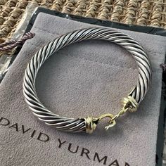 Product Details David Yurman’s Artistic Signature, Cable Began As A Bracelet That He Hand-Twisted From 50 Feet Of Wire. For The Past 30 Years, He Has Evolved The Twisted Helix Into A Myriad Of Designs. Sterling Silver 14-Karat Yellow Gold Cable, 7mm Hook Clasp Style Number: B04460 S4 Available For Pickup And Try On In New York City. Artistic Signature, Jewelry Aesthetic, David Yurman Jewelry, Buckle Bracelet, Hook Clasp, Fine Jewels, Arm Candy, David Yurman, Jewelry Branding