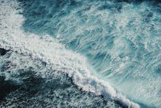 an aerial view of the ocean with waves