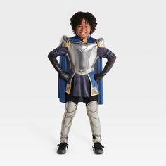 a young boy dressed in a knight costume