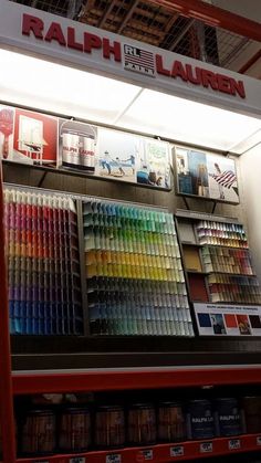 there is a display in the store with many colors on it's walls and shelves