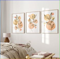 three framed art prints on the wall above a bed in a room with white walls