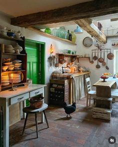 an old fashioned kitchen with lots of pots and pans