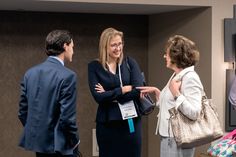 three women and one man are talking to each other