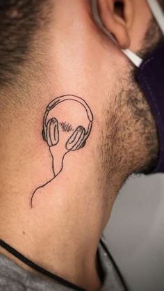 a man with headphones tattoo on his neck