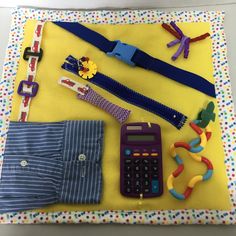 various items are laid out on a yellow cloth with polka dot trimmings and ribbons