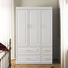 This classic armoire brings a clean, minimalist charm to your bedroom, living room, or home office. Crafted from a combination of solid and engineered wood, it features a white finish and golden handles for a touch of elegance. With three hinged doors and four exterior drawers, it offers ample storage space for your clothes, linens, and essentials. This armoire also includes a clothing rod and three shelves, each with a 15 lbs. weight capacity. A tip-over restraint device is included for added s Bedroom Built Ins, Armoire Dresser, Wardrobe Bed, Corner Wardrobe, Wood Armoire, Bedroom Makeup Vanity, Small Space Bedroom, Teen Bedroom Furniture, Bedroom Headboard