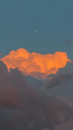 an orange cloud with the moon in the sky