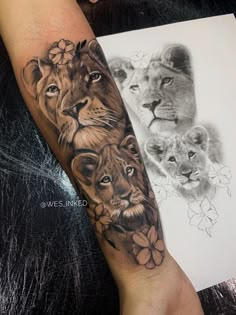 an arm tattoo with lions and flowers on it