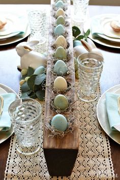 an easter table setting with blue and white eggs