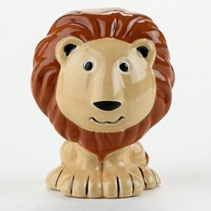 a ceramic figurine of a lion on a white background