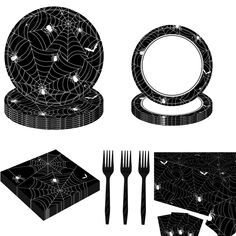 a set of black and white halloween themed tableware with spider webs on it