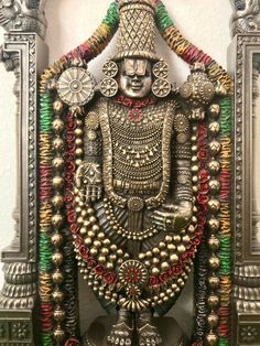 the statue is made out of metal and decorated with beads