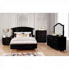 a bedroom with white walls and black furniture