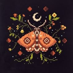 a cross stitched picture of a moth on a black background