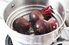 beets are being cooked in a pot on the stove