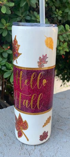 a coffee cup with the words hello fall painted on it