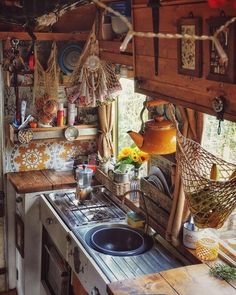 a kitchen filled with lots of pots and pans next to a stove top oven