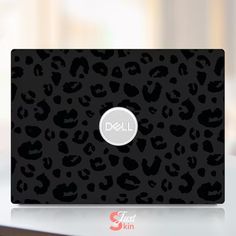 the dell laptop has a black and white leopard print pattern on it's cover