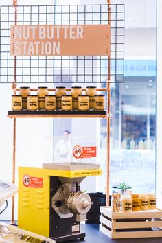 an assortment of nuts and other food items on display in a store with a sign that says nut butter station