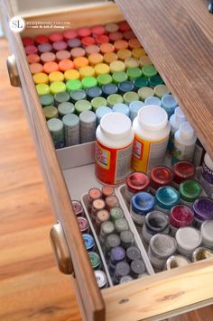 an open drawer filled with lots of paint